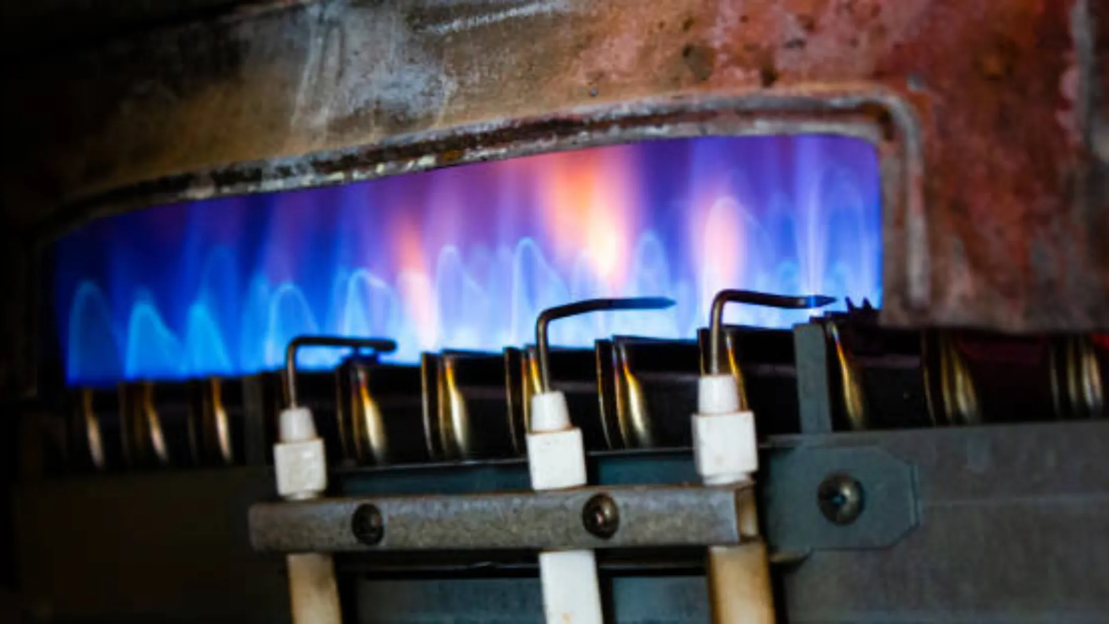 Close-up of the burner's blue flame for Water Heater Pilot Light.